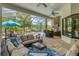 Outdoor kitchen with built-in grill, stone accents, and seating area at 7336 Haddington Cv, Bradenton, FL 34202