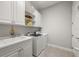 Laundry room with built-in cabinets and shelving at 7336 Haddington Cv, Bradenton, FL 34202