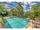 Inviting screened pool with spa and waterfall feature at 7336 Haddington Cv, Bradenton, FL 34202