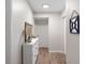 White hallway with light wood flooring and built in shelving at 1712 Lakeside Dr # 1712B, Venice, FL 34293