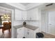 White kitchen with granite countertops and ample cabinet space at 1712 Lakeside Dr # 1712B, Venice, FL 34293