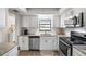 Modern kitchen with white cabinets, granite counters, and stainless steel appliances at 1712 Lakeside Dr # 1712B, Venice, FL 34293