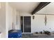 Front entrance with dark door, wall lamp, and potted plants at 1712 Lakeside Dr # 1712B, Venice, FL 34293