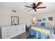 Bedroom with a queen bed, ceiling fan, dresser, and hardwood floors at 1712 Lakeside Dr # 1712B, Venice, FL 34293