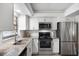 Modern kitchen with white cabinets, granite counters, and stainless steel appliances at 1712 Lakeside Dr # 1712B, Venice, FL 34293
