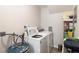 Functional laundry room with washer, dryer, and storage shelving at 1712 Lakeside Dr # 1712B, Venice, FL 34293