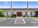 Condo building entrance with red door and landscaping at 1712 Lakeside Dr # 1712B, Venice, FL 34293