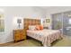 Bright bedroom with bamboo headboard, coral bedding, and access to patio at 129 12Th E Ave, Palmetto, FL 34221