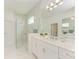 Spa-like bathroom with walk-in shower and double vanity at 14359 Skipping Stone Loop, Parrish, FL 34219