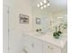 Bright bathroom boasts a white vanity with quartz countertop, and a large mirror at 14359 Skipping Stone Loop, Parrish, FL 34219