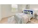 Bedroom with light walls, wood floors, and blue velvet headboard at 14359 Skipping Stone Loop, Parrish, FL 34219