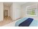 Bedroom with light walls, wood floors, and a view to the backyard at 14359 Skipping Stone Loop, Parrish, FL 34219