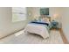 Cozy bedroom featuring wood floors, blue accents, and ample light at 14359 Skipping Stone Loop, Parrish, FL 34219