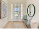 Bright entryway with a bench, mirror, and hardwood floors at 14359 Skipping Stone Loop, Parrish, FL 34219