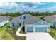 Charming one-story house with light blue exterior and gray roof at 14359 Skipping Stone Loop, Parrish, FL 34219