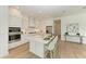 Modern kitchen features white cabinets, a large island, and stainless steel appliances at 14359 Skipping Stone Loop, Parrish, FL 34219