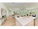 Open concept kitchen with island and adjacent living room with sliding glass doors at 14359 Skipping Stone Loop, Parrish, FL 34219
