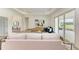 Living room with light colored sofas, hardwood floors and large window at 14359 Skipping Stone Loop, Parrish, FL 34219