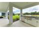 Outdoor kitchen with stainless steel appliances and white cabinetry at 14359 Skipping Stone Loop, Parrish, FL 34219