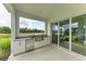 Outdoor kitchen with built-in grill and expansive water views at 14359 Skipping Stone Loop, Parrish, FL 34219