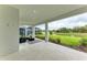 Covered patio with seating area and tranquil water views at 14359 Skipping Stone Loop, Parrish, FL 34219