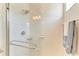 Bright shower with glass enclosure and white subway tile at 14359 Skipping Stone Loop, Parrish, FL 34219