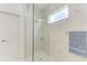 Spacious shower with marble tile, pebble floor, and glass enclosure at 14359 Skipping Stone Loop, Parrish, FL 34219