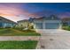 Two-story house with gray roof, light blue siding, and a two-car garage at 14359 Skipping Stone Loop, Parrish, FL 34219