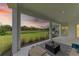 Relaxing covered patio with outdoor furniture and water view at 14359 Skipping Stone Loop, Parrish, FL 34219