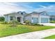 Two-story home with light blue siding, gray roof, and two-car garage at 14359 Skipping Stone Loop, Parrish, FL 34219