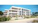 Modern beachfront building with pool and lush landscaping at 70 Avenida Veneccia # 401, Sarasota, FL 34242