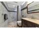 Updated bathroom with gray tile, walk-in shower, and modern vanity at 15440 County Road 675, Parrish, FL 34219