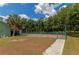Private basketball court with a green fence and walkway at 15440 County Road 675, Parrish, FL 34219