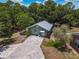 Aerial view of a guest house with driveway and lush landscape at 15440 County Road 675, Parrish, FL 34219