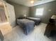 Guest bedroom with two twin beds and tile flooring at 15440 County Road 675, Parrish, FL 34219