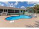 Inviting kidney-shaped pool with brick coping and spa at 15440 County Road 675, Parrish, FL 34219
