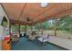 Relaxing screened porch with seating and wooded views at 15440 County Road 675, Parrish, FL 34219