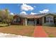 Brick and green house exterior with solar panels and a brick walkway at 15440 County Road 675, Parrish, FL 34219