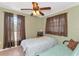 Bedroom with twin and full beds, ceiling fan, and large windows at 15440 County Road 675, Parrish, FL 34219
