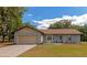 Tan house with attached garage and landscaping at 15440 County Road 675, Parrish, FL 34219