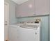 Bright laundry room with washer, dryer, and cabinets at 15440 County Road 675, Parrish, FL 34219
