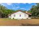Rear view of house with stone chimney and screened porch at 15440 County Road 675, Parrish, FL 34219