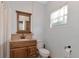 Clean bathroom with wood vanity and a large mirror at 15440 County Road 675, Parrish, FL 34219