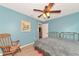 Bedroom with a queen bed, ceiling fan, and rocking chair at 15440 County Road 675, Parrish, FL 34219