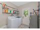 Laundry room with washer, dryer, shelving and exterior access at 15440 County Road 675, Parrish, FL 34219
