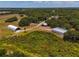 Aerial view of a property with outbuildings and expansive grounds at 15440 County Road 675, Parrish, FL 34219