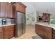 Modern kitchen with stainless steel refrigerator and ample storage at 15440 County Road 675, Parrish, FL 34219