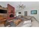 Cozy Gathering room boasts a brick fireplace and comfortable sectional sofa at 15440 County Road 675, Parrish, FL 34219