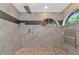 Spa-like bathroom with a large shower, heated towel rack, and arched window at 15440 County Road 675, Parrish, FL 34219