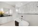 Bright bathroom featuring modern tub, walk-in shower, and modern vanity at 1805 Goldenrod St, Sarasota, FL 34239